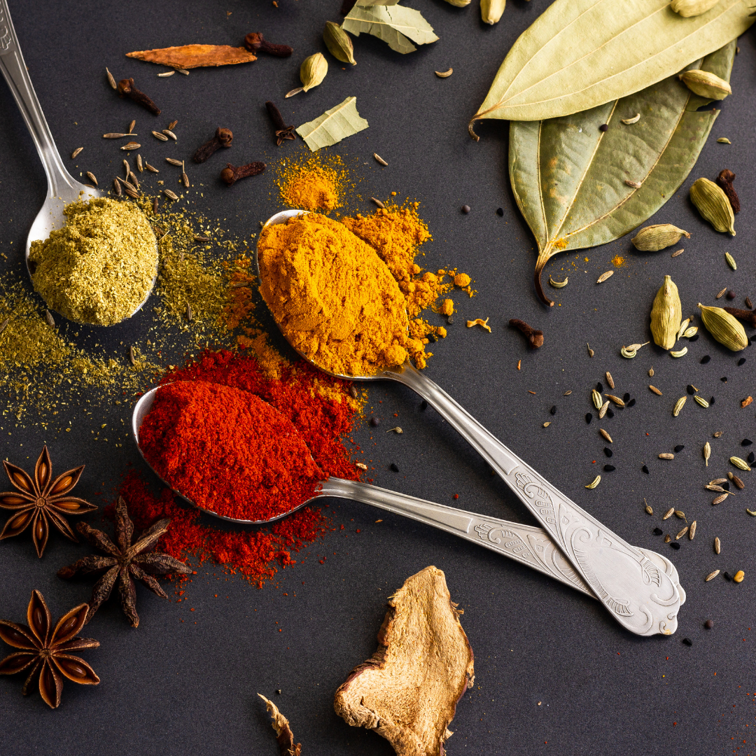 A variety of Indian spices are displayed in this image. The spices include turmeric, cumin, coriander, chili powder, garam masala, and ginger. These spices are commonly used in Indian cuisine to add flavour and aroma to dishes.